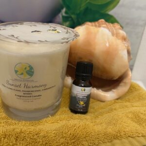 Close-up of handmade candle labeled “Home” surrounded by dried botanicals and Ylang Ylang aroma